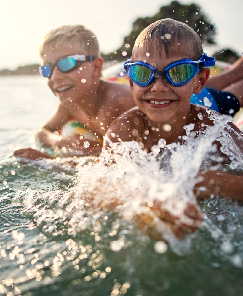 children splash in the water wearing their Invisalign First for kids