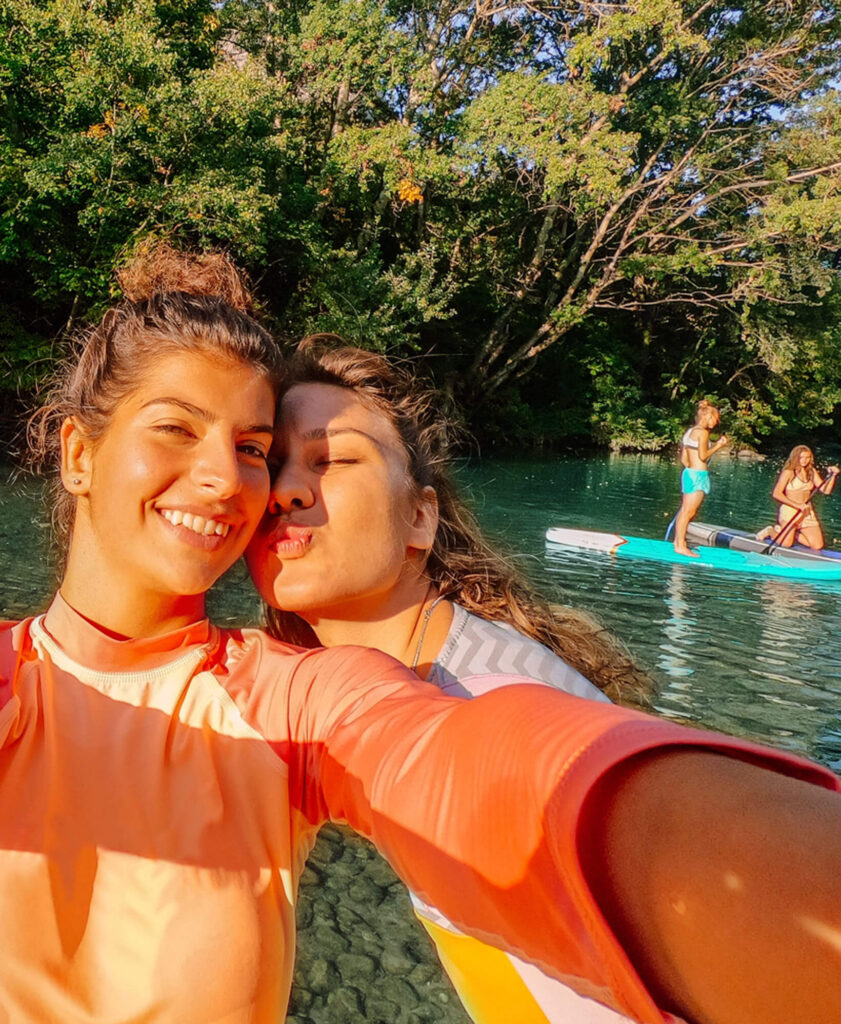 girls take a selfie on the river wearing their Invisalign for teens
