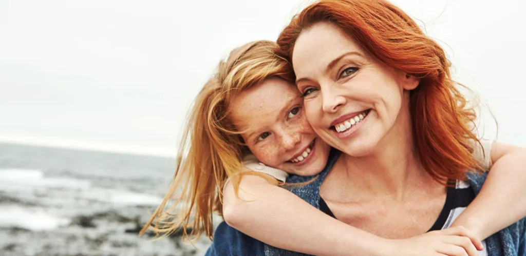 mom and daughter at the beach after learning invisalign faqs