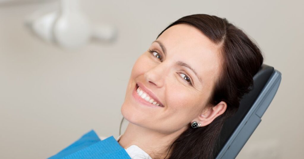 adult at the dentist for her teeth cleaning with braces