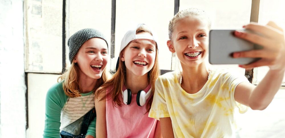 teens take a seflie together after their back to school orthodontic exam