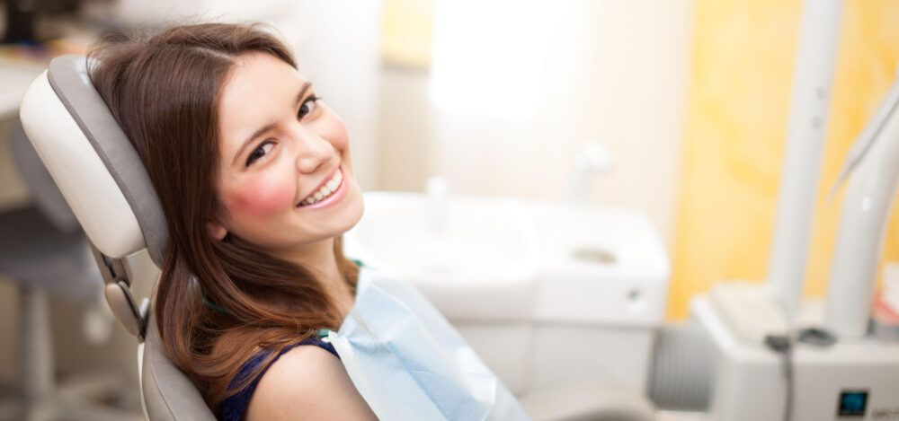 Girl at an Orthodontist office learning about evolution of braces