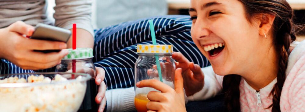 A girl having some organic refreshments with a friend: what drinks are bad for your teeth?