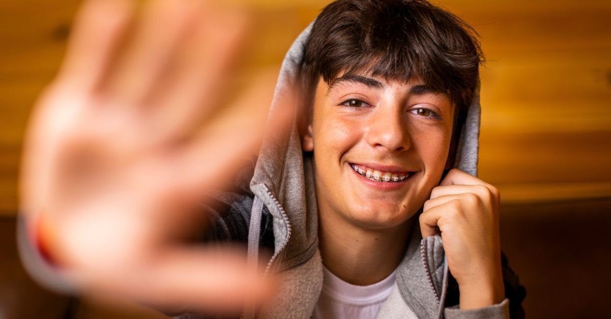 teen wearing lightforce braces after learning about Fake braces