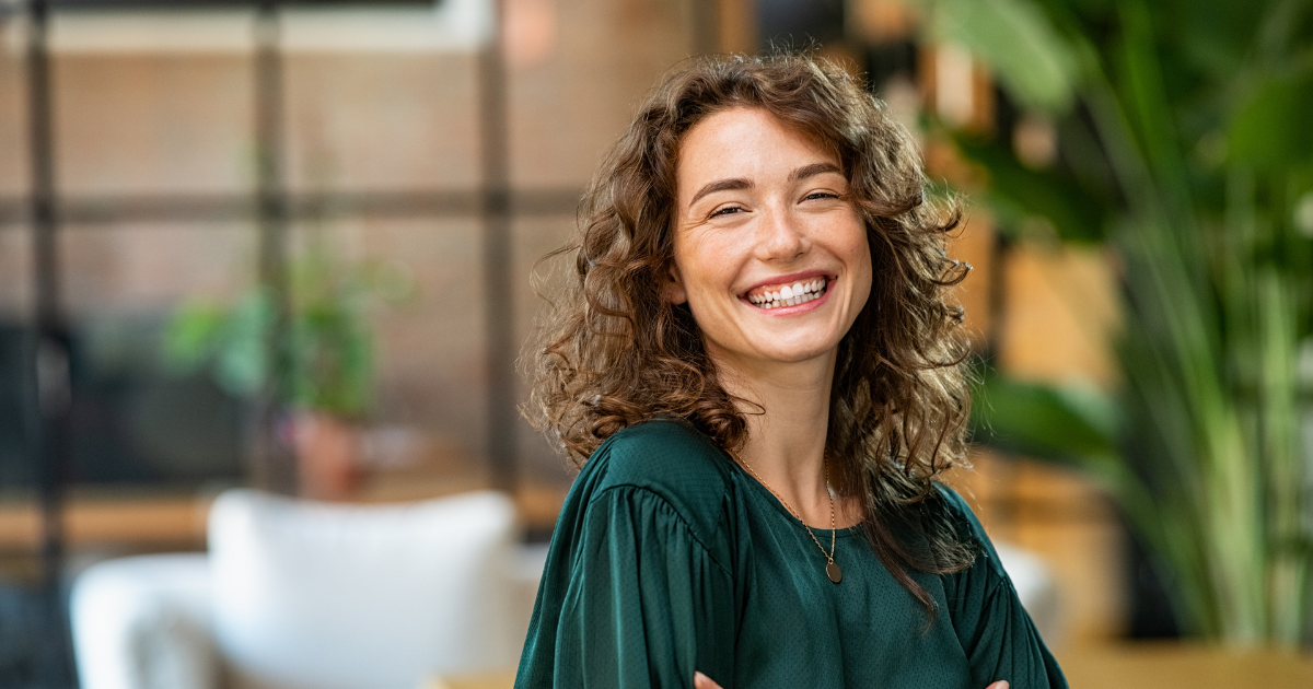 Adult woman wearing green blouse, smiling, Matsumoto Orthodontics & Periodontics - MSE and MARPE treatment in Wilmington, NC
