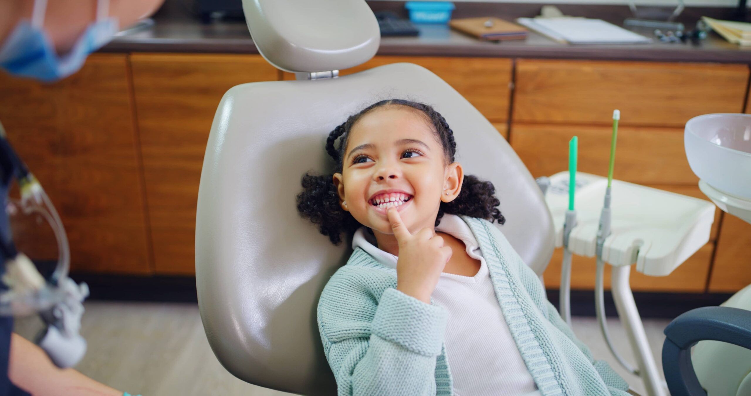 child and consultation with dentist in office for dental checkup, show cavity and extraction