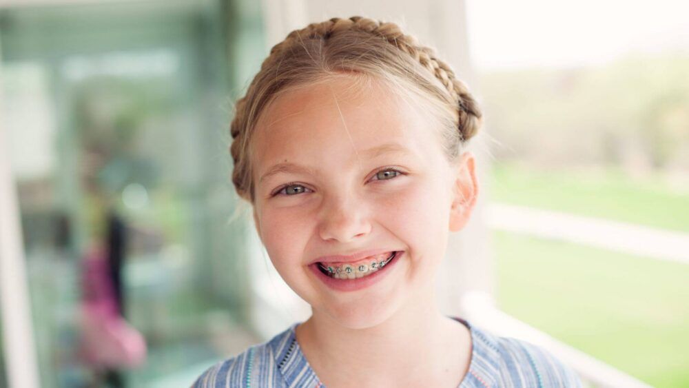 young girl with braces smiling