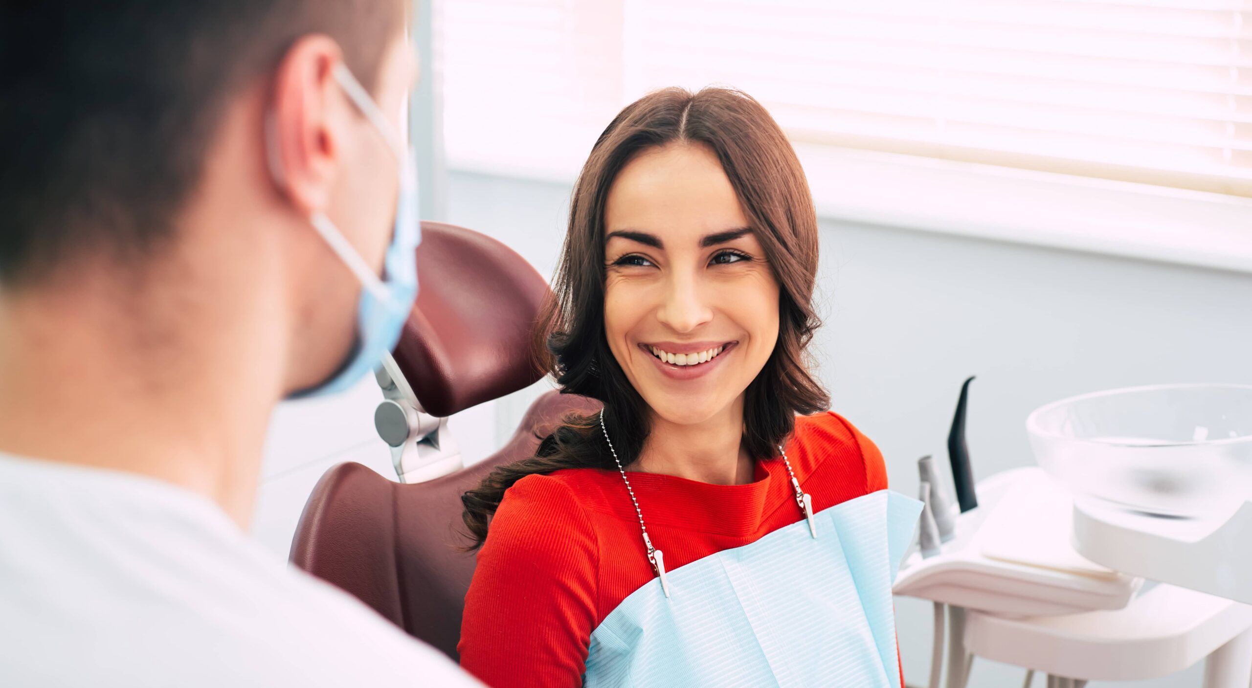 On the road to recovery. Bodacious girl in the dental chair next to the dentist with happy emotions
