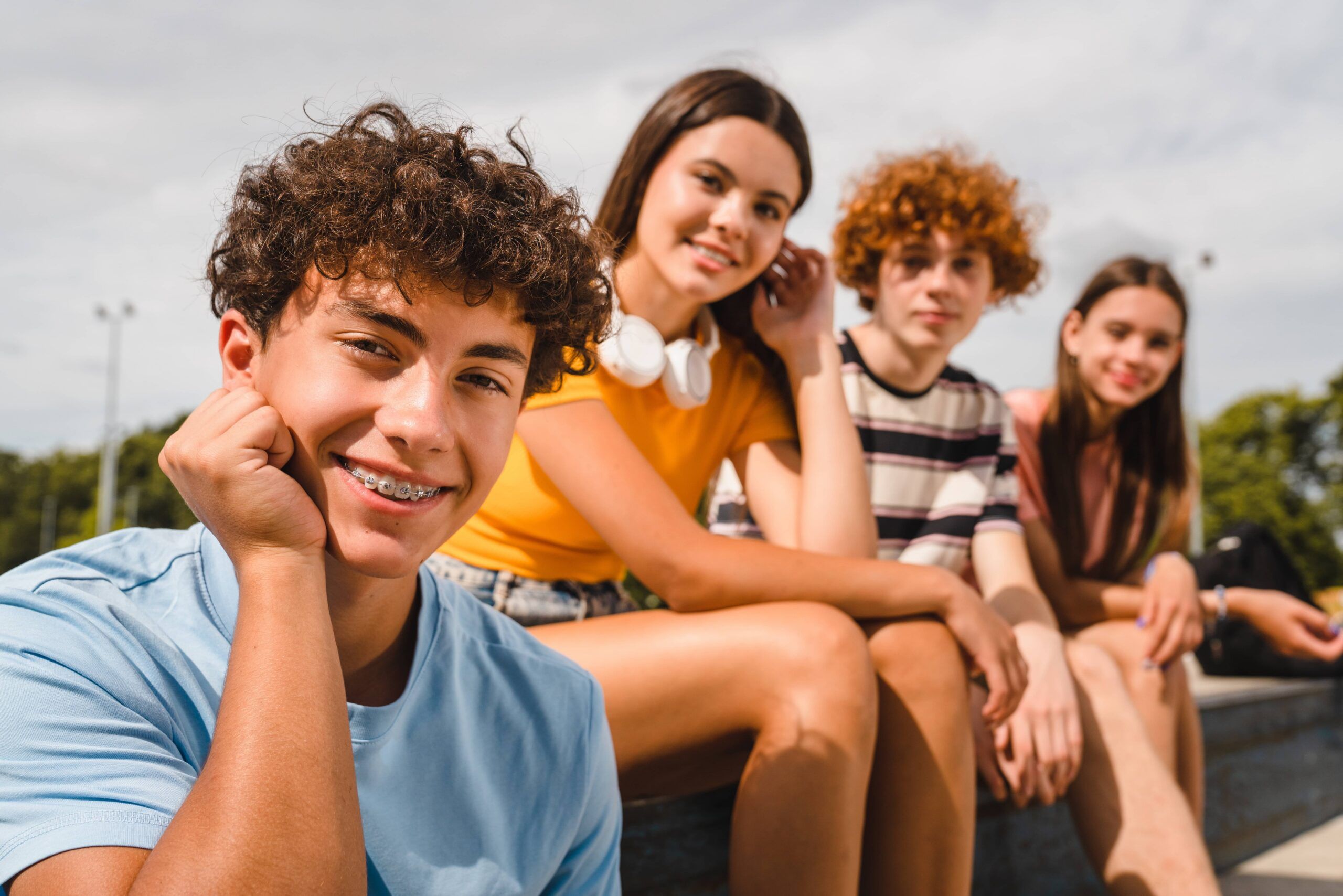 Close up photo of positive multiracial teenagers high school pupils