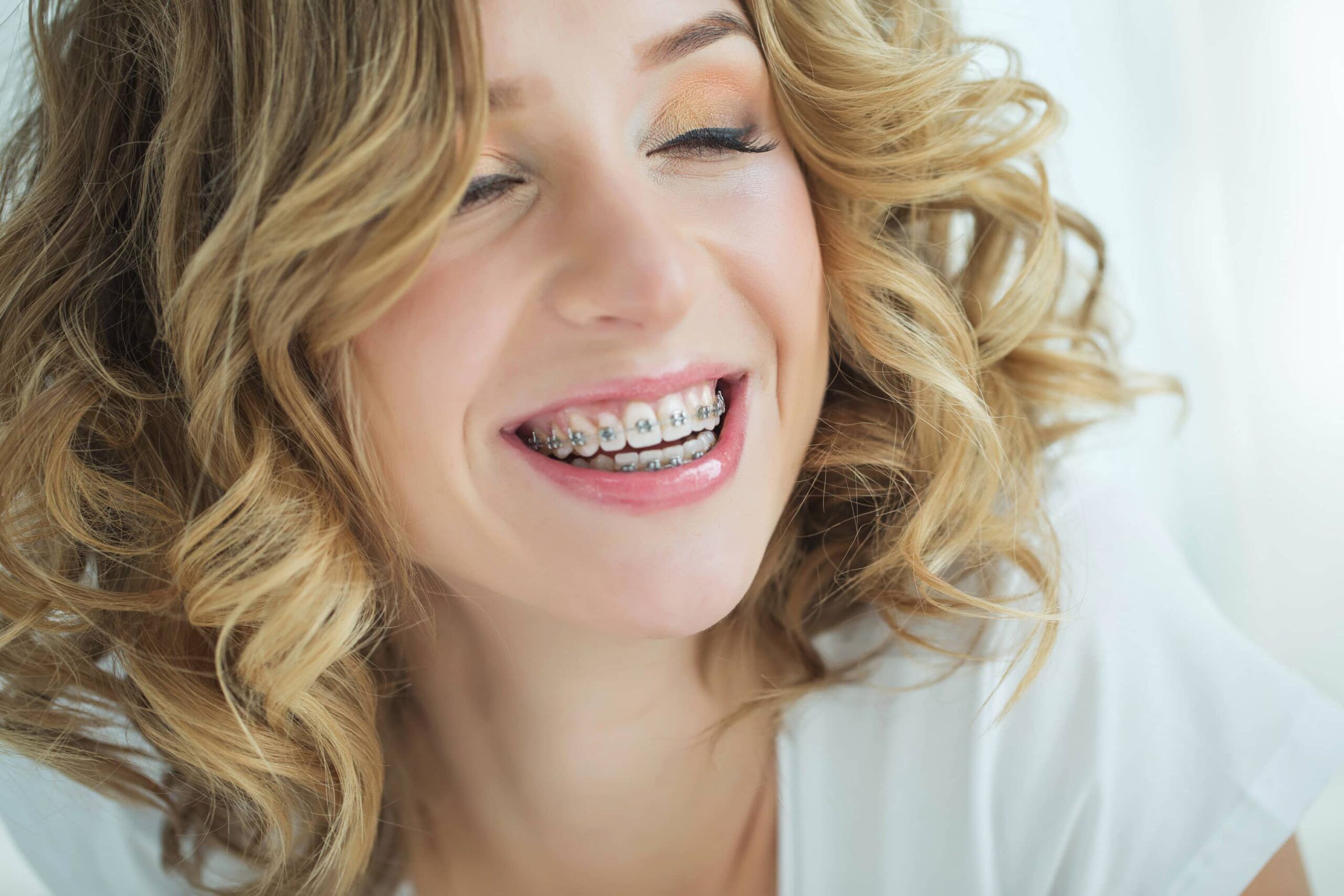 Young beautiful smiley woman with braces